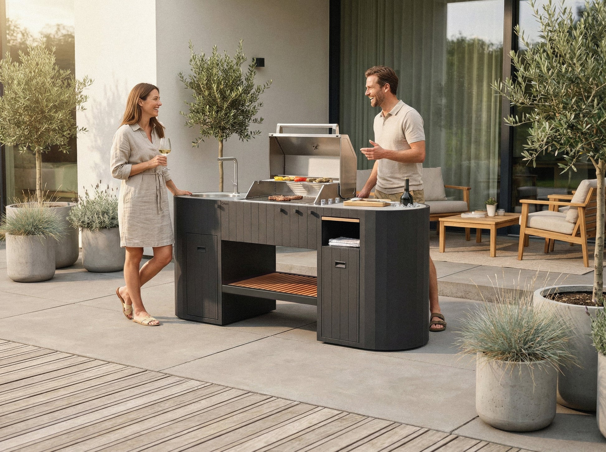 Friends grilling on the OVO GL outdoor kitchen on a stone patio